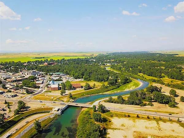 Aerial view of High River and the Highwood River winding through green parkland